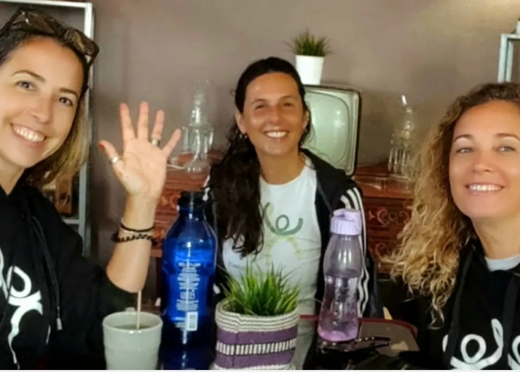 The three founders of 4UnityProject, smiling, sitting together at a table