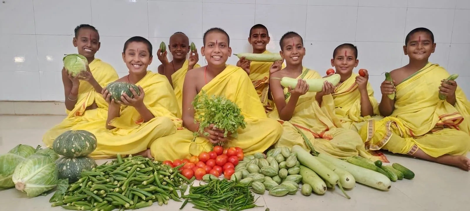 Yoga Mission children in Varanasi, sitting with fresh vegetables